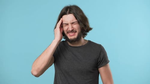 Young Man Suffering from a Severe Headache