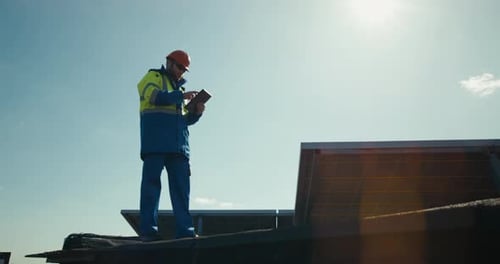 Technician Walking Next To Solar Panels
