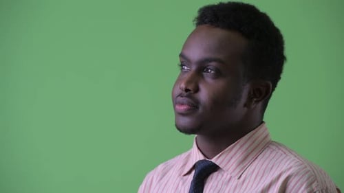 Closeup Profile View of Happy Young African Businessman Smiling