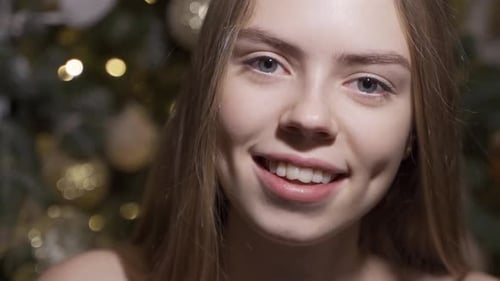Smiling Woman with Christmas Tree