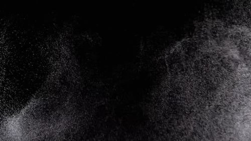 Glittering White Particles Against Black Background