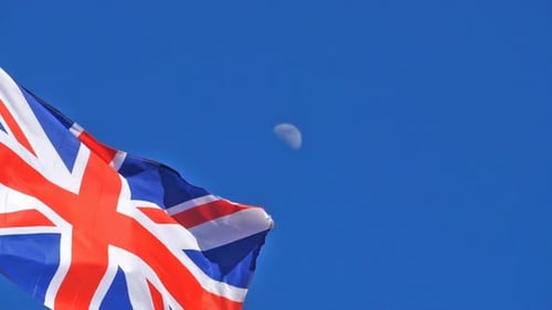 UK Flag Waving Against Blue Sky