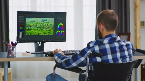 Person in Wheelchair Using Computer for Design