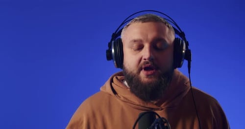 Closeup of a European Podcast Blogger Smiling While Broadcasting His Live Audio Podcast in a Studio