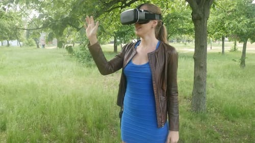 Woman Using Virtual Reality Headset in Park