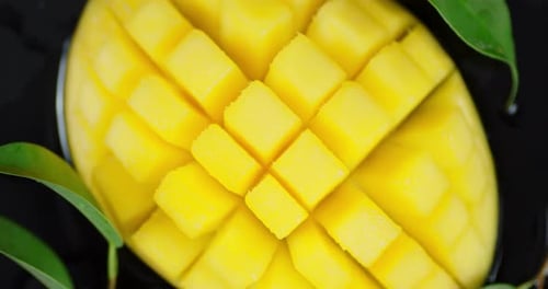 Sliced Fresh Mango with Leaves Rotates Slowly