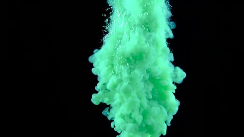 Real Shot Green Paint in the Water in Slow Motion. Ink Swirling Underwater. Cloud of Ink Collision