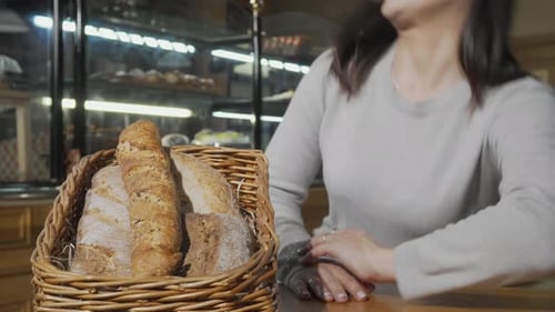 Woman Smiling in Bakery with Bread