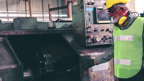 Senior Factory Worker Teach How to Use Machine Equipment in the Factory Workshop