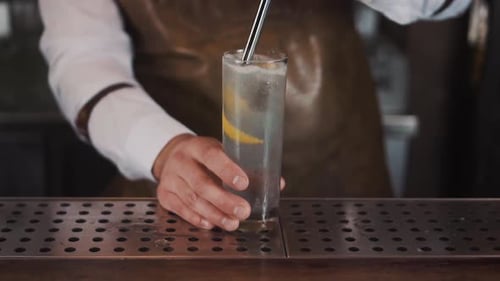 Bartender Creates Lemon Cocktail with Ice