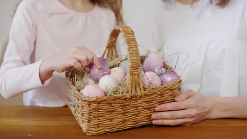 Mum and Daughter Posing with Basket of Easter Eggs