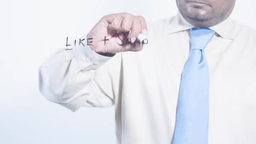 Man Writes Like and Share Message on Glass