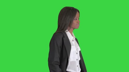 Casual African American Businesswoman Walking on a Green Screen, Chroma Key.