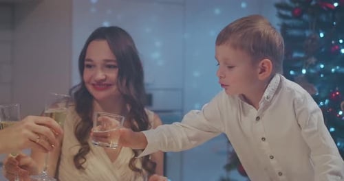 Family Celebrating Christmas in Festive Home Kitchen