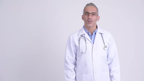 Mature Doctor in White Coat Presents