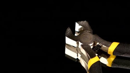 Close Up of Chrome Wire Cutters on Black Surface