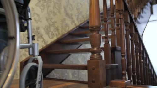 Wheelchair Parked at Staircase Showing Inaccessibility