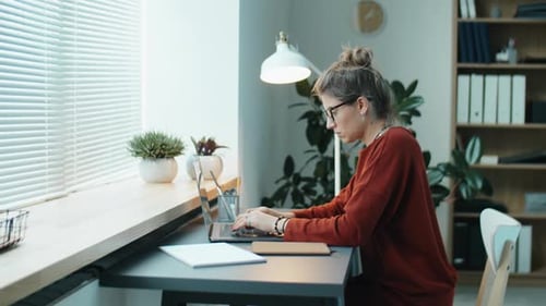 Young Businesswoman Working on Laptop at Office Desk