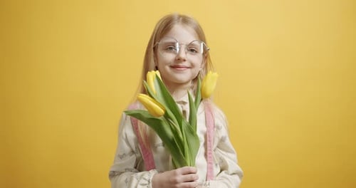 Smiling Girl Holding Yellow Tulips Bouquet