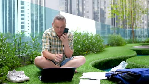 Young Adult Working Remotely in Urban Green Space