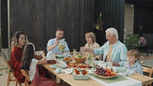 Family Enjoys Meal Together Outdoors