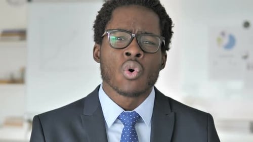 Young Adult Shouting and Looking Upset at Work