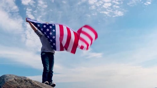 Happy Child Holds American Flag Outdoors