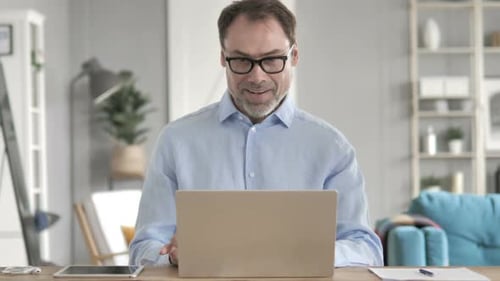 Man Excited Working on Computer at Home