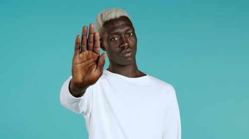 Young Man Points Finger at Camera