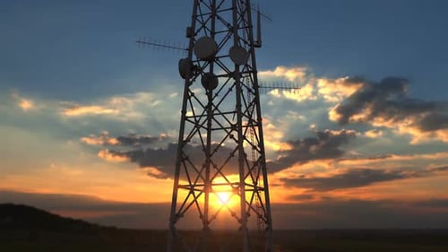 Flying Up Close To Telecommunication Tower Against Scenic Sunset