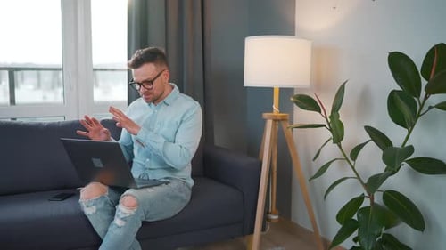 Adult Man Using Laptop Computer on Couch