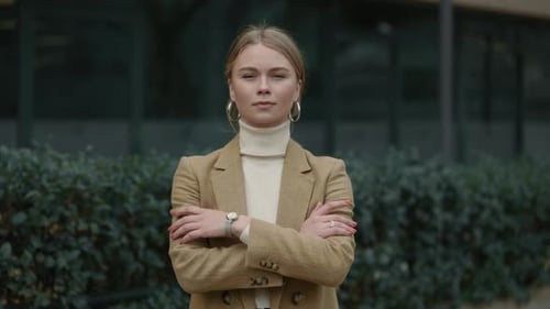 Young Adult Woman Posing Outdoors With Arms Crossed