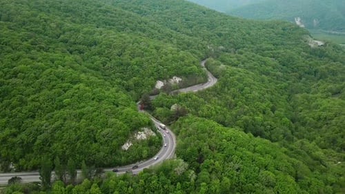 Aerial Fly Over Caucasian Mountains and Winding Road with Cars