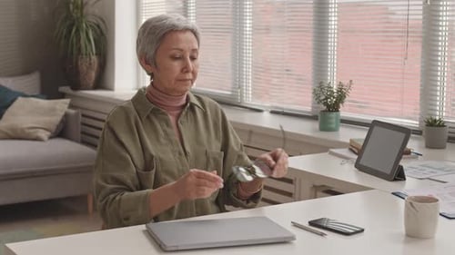 Woman Stretching Neck at Home Office Desk