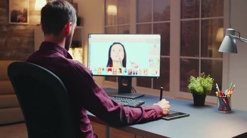 Male Photographer Editing Photos in Office