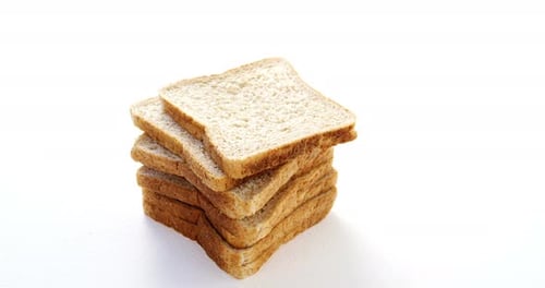 Stacked Slices of Whole Wheat Bread on White Surface