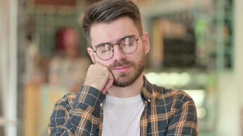 Portrait of Tired Young Man Taking Nap