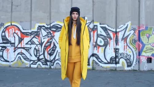Woman Posing in Yellow in Urban Setting