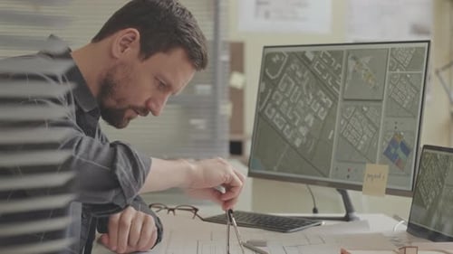 Professional Engineer Working on Building Plan in Office