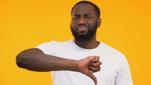 Unsatisfied Afro-American Man Showing Thumbs Down, Dislike, Negative Review