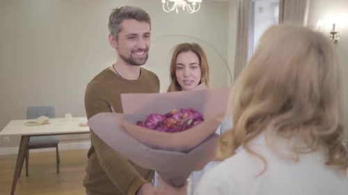 Couple Brings Birthday Flowers to Woman at Home