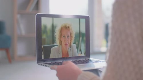 Woman in Video Call Holding Laptop at Home