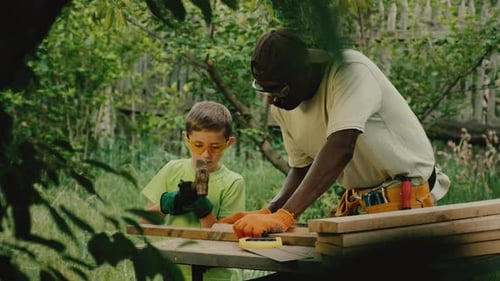 Man and Child Build Together Outdoors