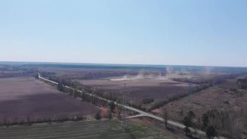 Aerial view of fields with farming tractor. Sowing agricultural crops field. Agriculture concept