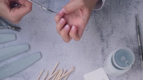 Manicurist Giving a Manicure with Metal Tools