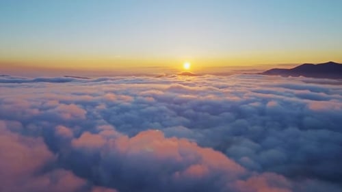 Aerial View of Dreamy Sunrise Above Cloudscape