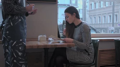 Woman Ordering Food at Bright Cafe Table