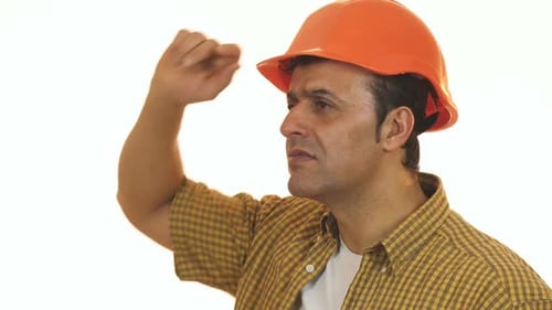 Mature Professional Builder in Hardhat Looking Disappointed