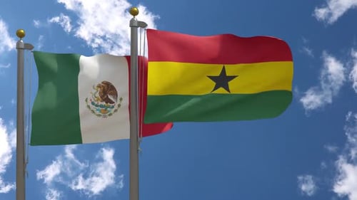 Flags of Mexico and Ghana Waving Against a Blue Sky