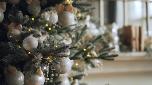 Close-up Shot of Artificial Christmas Tree Decorated with Beautiful Silver Balls and Lights Ready